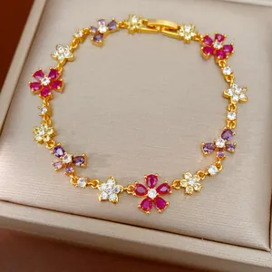 Detailed view of a gold-plated bracelet with multi-colored zircon flowers and butterfly charms