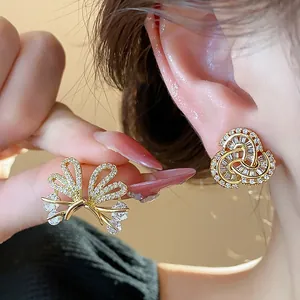 Detailed view of 14k gold-plated butterfly stud earrings with sparkling zircon stones