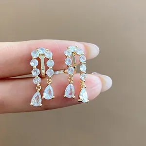 Close-up of 18k gold plated ear clips with sparkling water drop cubic zirconia