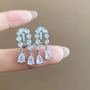 Macro detail view of silver teardrop clip-on earrings with sparkling cubic zirconia stones