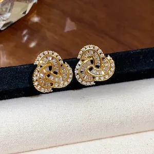 Close-up of 14k gold plated heart stud earrings featuring sparkling cubic zirconia