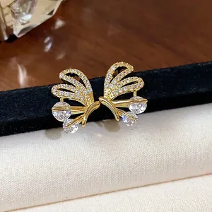 Close-up of 14k gold-plated butterfly stud earrings with sparkling cubic zirconia stones.