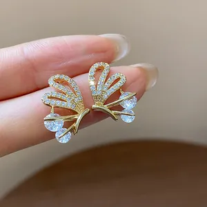 Close-up of 14k gold plated butterfly earrings featuring pave cubic zirconia stones