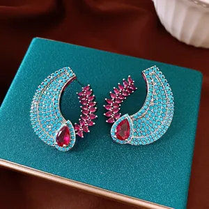 Luxury court style crescent earrings with ruby-red stones and turquoise pave beads.