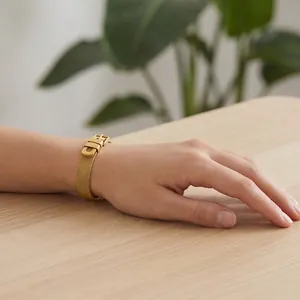 Detailed view of a gold 304 stainless steel Milanese mesh bracelet on a wrist