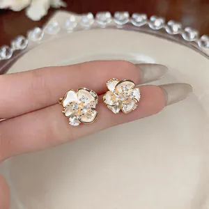 Close-up of elegant 18k gold plated floral earrings with sparkling zircon stones