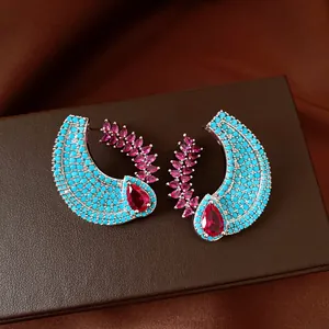 Exquisite detail view of luxury turquoise and ruby-red zircon earrings in palace style.