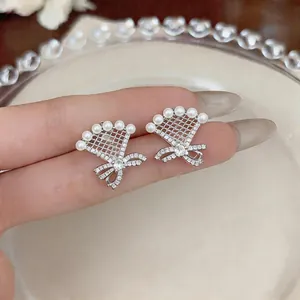 Close-up detail of fan-shaped bowknot clip-on earrings with pearls and cubic zirconia