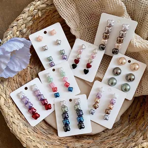 Elegant assorted shell-like flower stud earrings set with silver needles in soft colors
