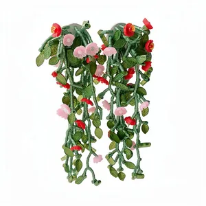 Handmade forest style earrings featuring green glass leaves and pink flower charms