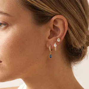 Detail of 18k gold plated stainless steel earring set with pear-cut blue zircon