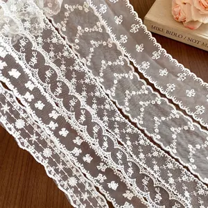 French style white floral lace choker ribbons displayed on a wooden surface with a book