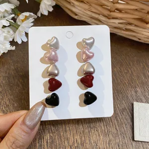 Set of 5 pairs of glossy heart-shaped stud earrings in assorted colors on display card.