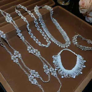Detail view of handmade French style stacked pearl tassel necklaces and bracelets in a tray