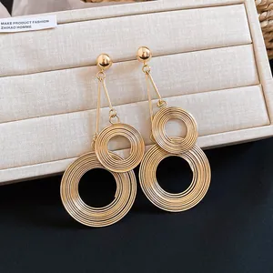 Detailed view showing the metallic texture of oversized multi-layer gold circular earrings