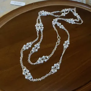 Detail showing the intricate beadwork and lustrous pearls of the French necklace