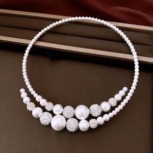 Close-up of elegant baroque pearl choker with sparkling rhinestone crystal balls.