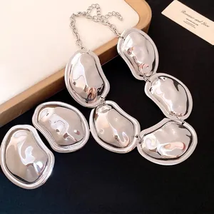 Minimalist silver metal statement necklace with wrinkled oval pebble charms for women