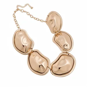Bold gold metallic statement necklace with organic pebble-shaped pleated charms