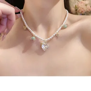 Elegant pearl beaded necklace with heart-shaped zircon and gold butterfly pendant