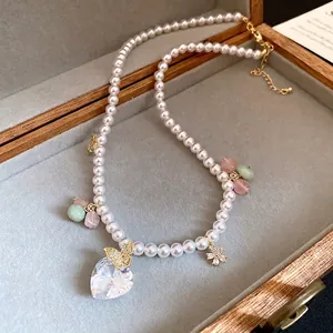 Elegant pearl necklace with heart crystal and butterfly charms in jewelry box