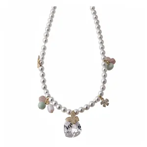 Elegant pearl beaded necklace with butterfly charms and a large crystal teardrop pendant