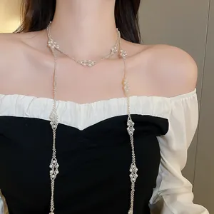 Detail of French style layered long necklace with handmade white pearl fringes on model