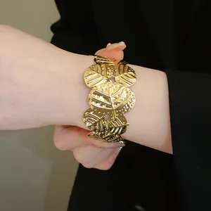 Elegant wide gold textured butterfly wing pattern open cuff bracelet for stylish women.