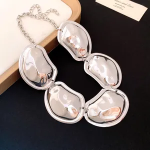 Detailed macro view showing the glossy pleated surface of the silver-toned oval link necklace