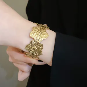 Detailed close-up showing a golden textured floral spliced open bangle on a wrist