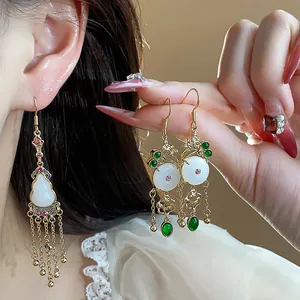 Detail shot of retro Chinese style 14K gold plated earrings with jade-like gourds