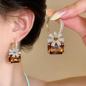 Detailansicht eleganter Reifenohrringe mit bernsteinbraunem Edelstein und Blumenmuster