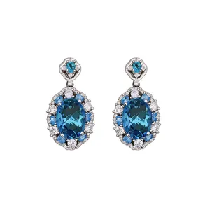 Elegant oval blue zircon drop earrings with a shimmering crystal halo in silver setting