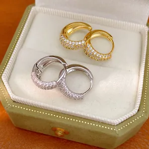Detail view of gold and silver plated hoop earrings with pavé set sparkling cubic zirconia