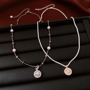 Detailed close-up view of elegant retro zircon starburst necklaces in silver and gold finishes