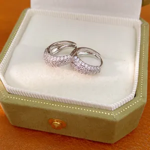 Detailed view of silver hoop earrings with pavé cubic zirconia in a velvet box