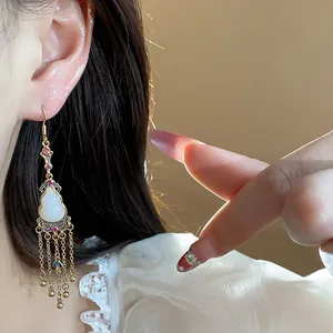 Close-up detail of retro 14K gold plated gourd tassel earring with colorful stones