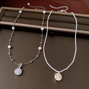 Detail shot of vintage zircon starburst necklaces with pearl and textured chains.