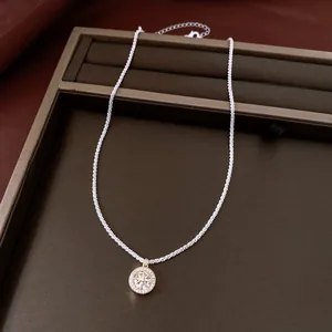 Close-up detail of a retro round star pendant necklace with sparkling cubic zircons