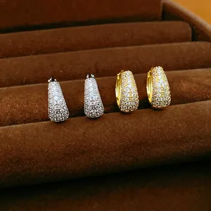 Detailed macro view of 14K gold plated hoop earrings paved with sparkling cubic zirconia