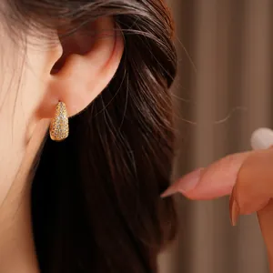 Close-up of elegant 14K gold plated hoop earrings with pave-set sparkling zircons
