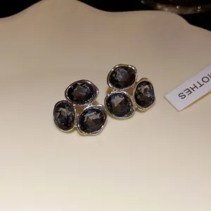 Elegant silver-toned stud earrings with dark grey faceted crystal stones in a cluster design