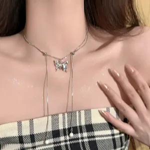 Elegant double-layer silver necklace with a diamond butterfly pendant and pearl tassels