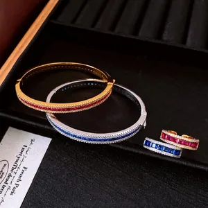 Vintage zircon bangle and ring set with red and blue stones in luxury jewelry tray