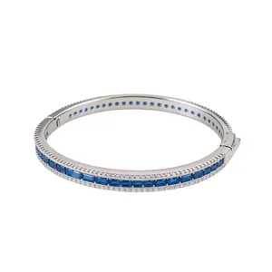Vintage court style silver bangle with blue emerald-cut cubic zirconia and clear accents