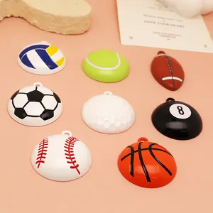 Macro view of assorted alloy sports ball charms including soccer and basketball for DIY jewelry