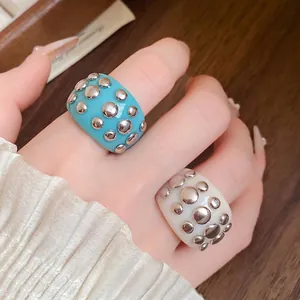 Trendy resin rings with silver metal rivets in turquoise and white for elegant women