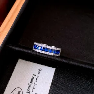 Detailed view of vintage silver ring featuring square blue zircon and pavé white stones