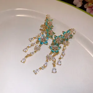 Exquisite detail of blue floral zircon earrings featuring sparkling teardrop tassels.