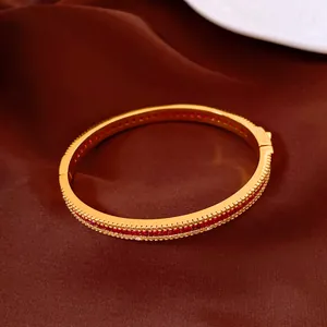 Close-up view of vintage gold-plated bangle inlaid with sparkling red zircon pavé stones